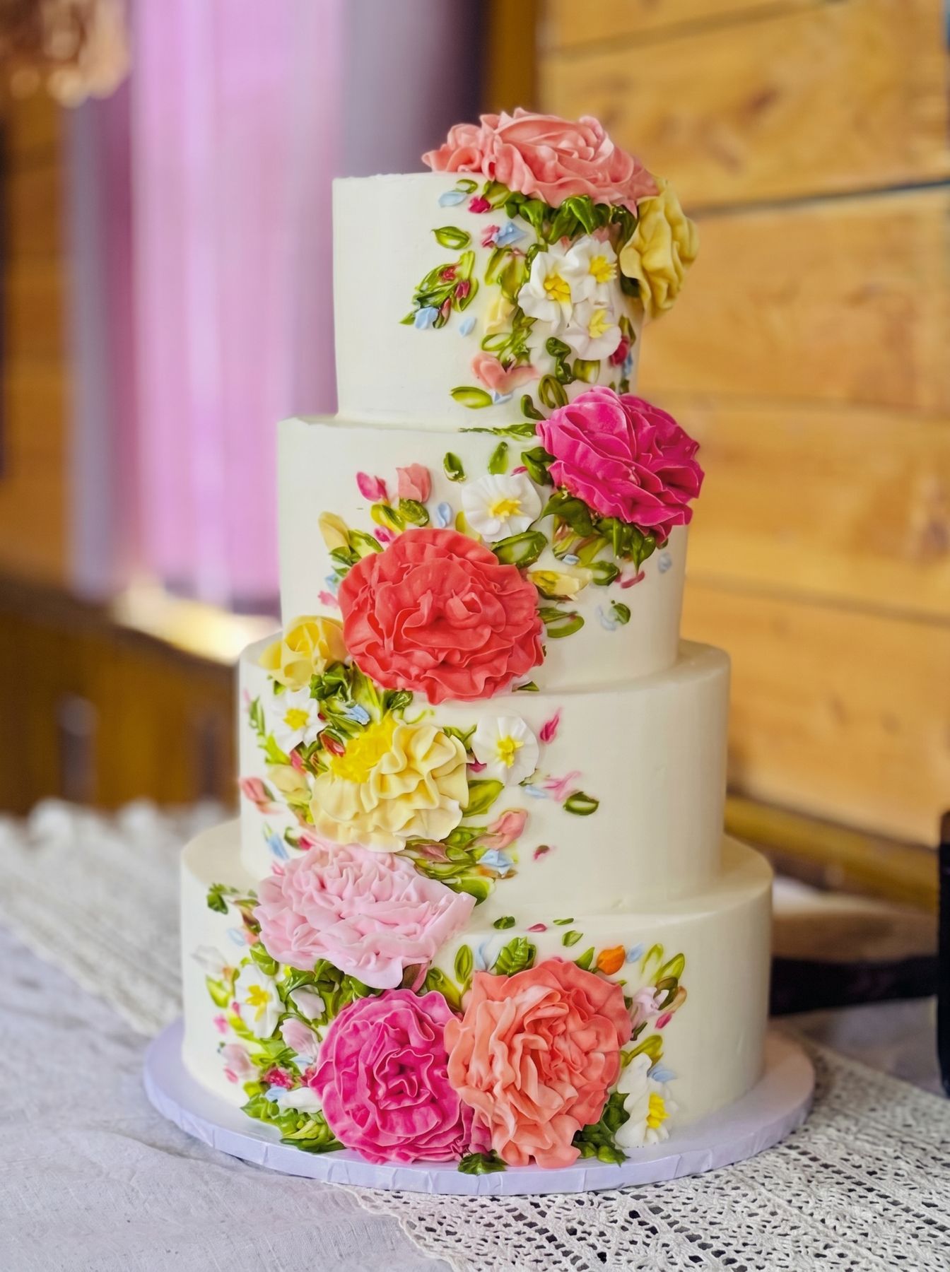 Four-tier custom wedding cake with hand-painted floral decorations by Warner's Bakery By Hil, Titusville, PA